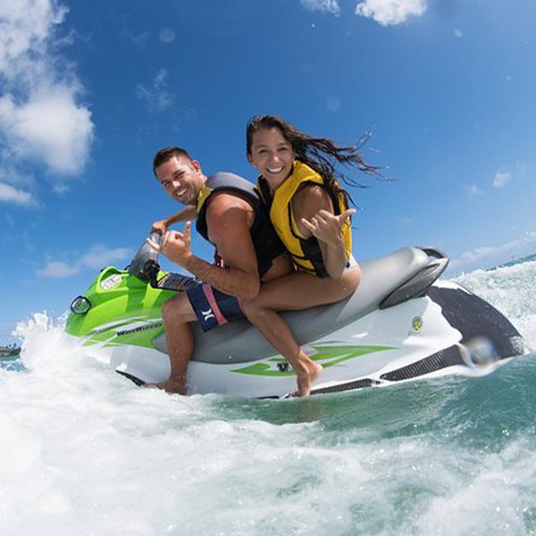 Male and female riding a jetski